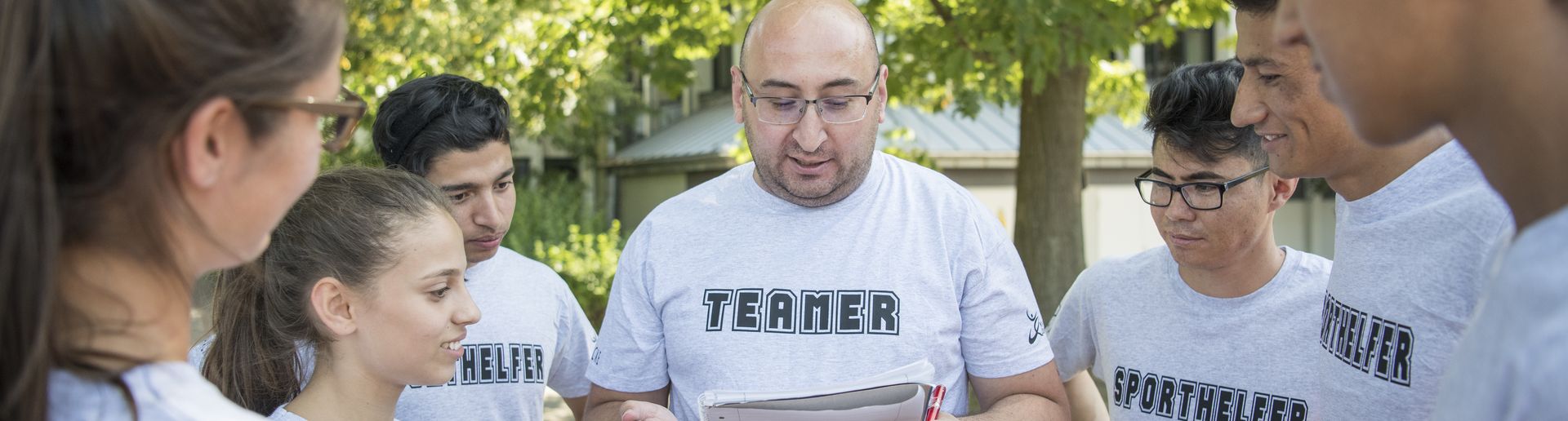 Übungsleiter erklärt Jugendlichen etwas